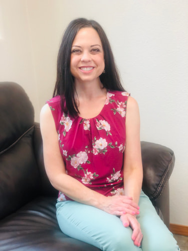 Angela Holland sitting on couch